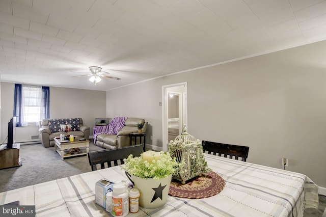 carpeted dining area with baseboards, crown molding, and ceiling fan