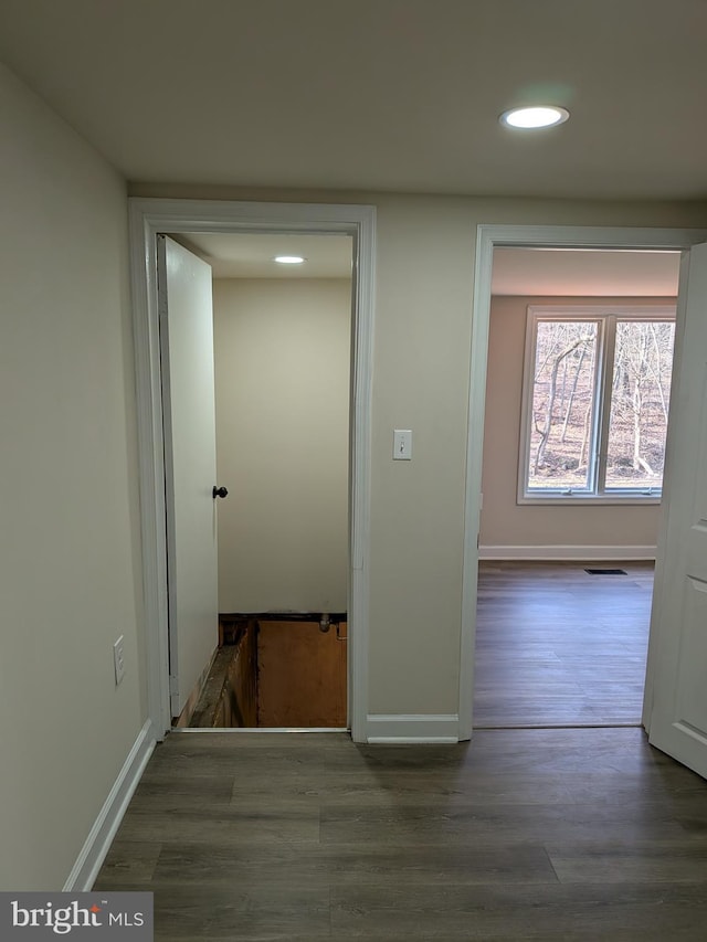 hall with recessed lighting, baseboards, and wood finished floors