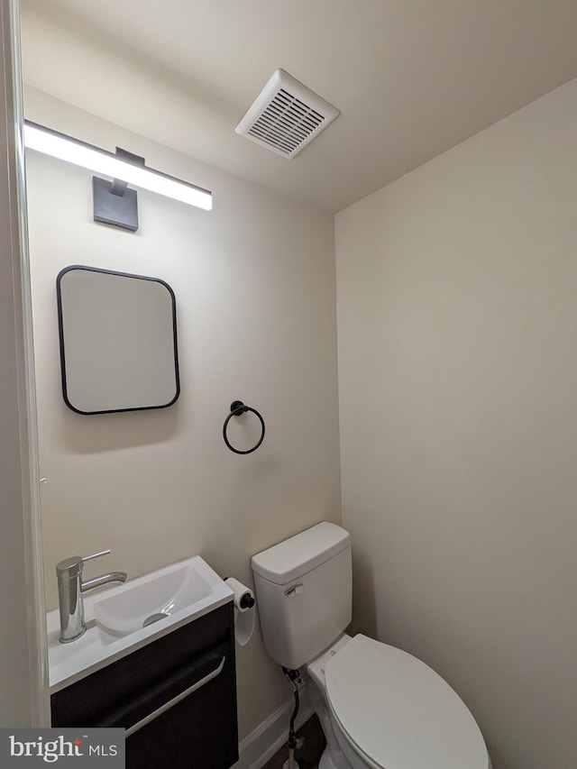 bathroom with visible vents, toilet, and vanity