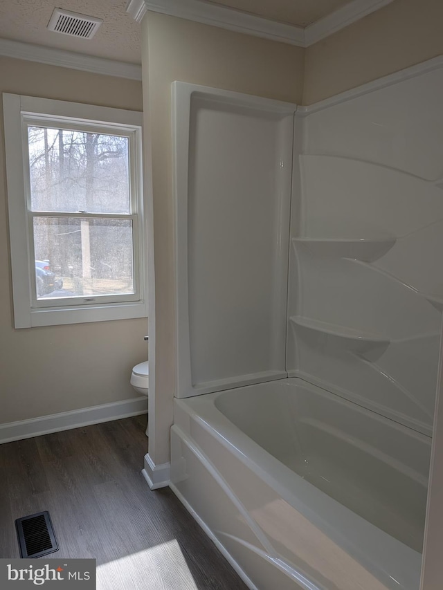 full bathroom with toilet, wood finished floors, visible vents, and baseboards