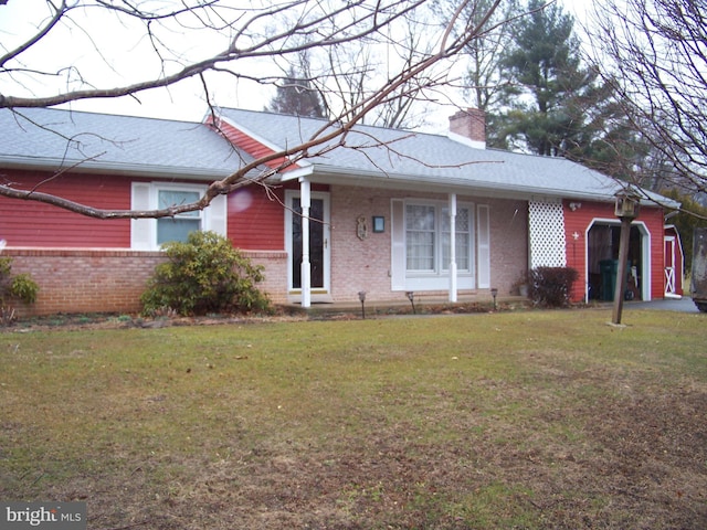 single story home featuring a front yard, brick siding, and a chimney