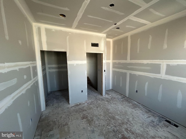 unfurnished bedroom featuring visible vents