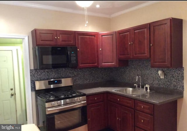 kitchen featuring stainless steel gas range oven, dark brown cabinets, black microwave, decorative backsplash, and a sink