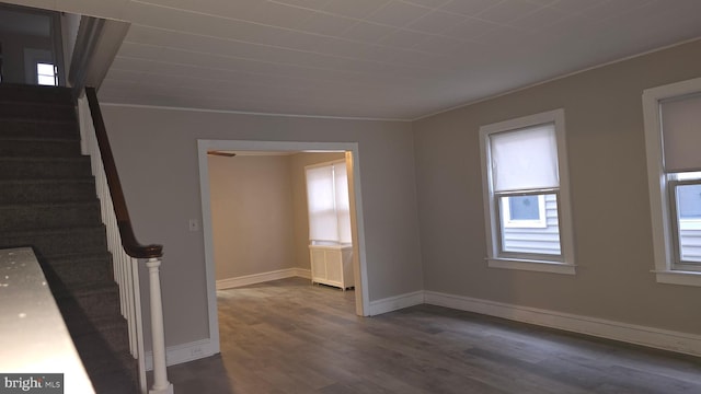 interior space with stairs, baseboards, and dark wood-style flooring