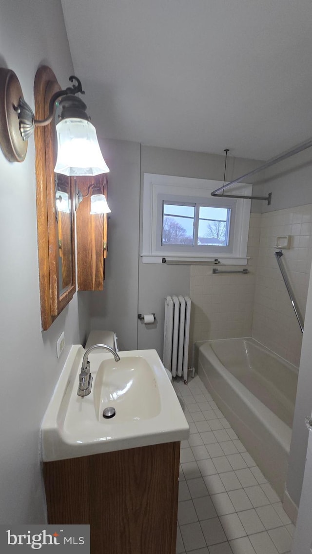 full bathroom with vanity, radiator,  shower combination, and tile patterned flooring