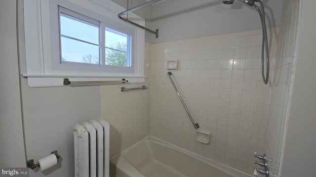 bathroom featuring tub / shower combination and radiator heating unit