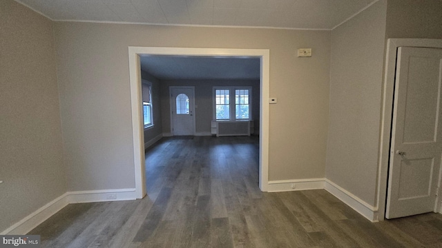 hall with baseboards, dark wood-type flooring, and crown molding