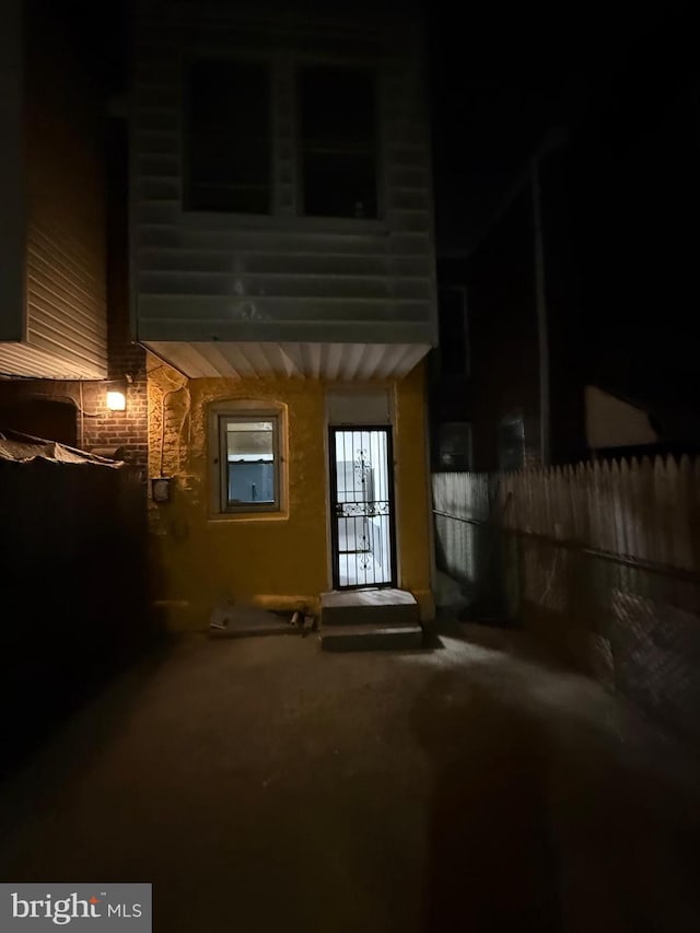 exterior entry at night with fence