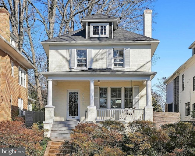 american foursquare style home featuring a porch