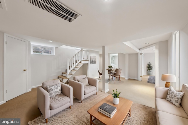 living area featuring stairway, light colored carpet, visible vents, and baseboards