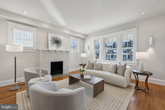 living room featuring recessed lighting, baseboards, a fireplace, and hardwood / wood-style flooring