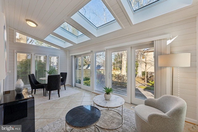 sunroom featuring vaulted ceiling with skylight