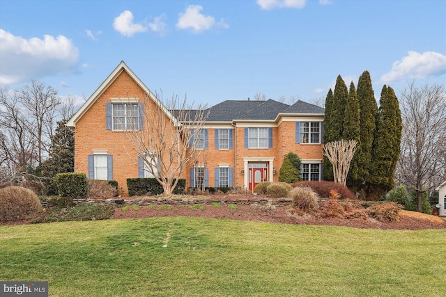 view of front of property with brick siding and a front lawn