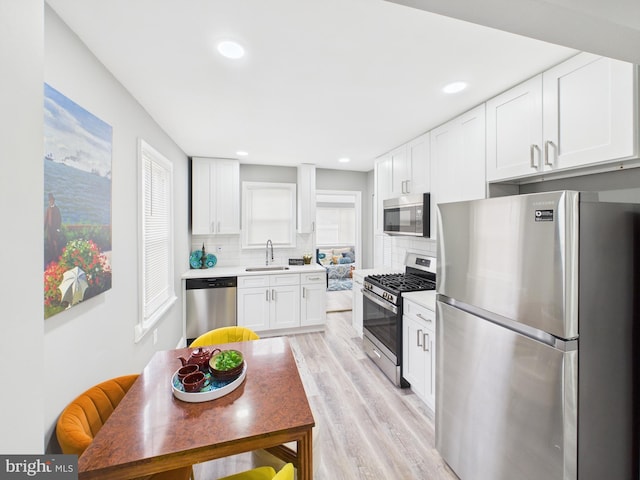 kitchen with light countertops, plenty of natural light, tasteful backsplash, and stainless steel appliances