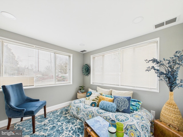 living area featuring visible vents and baseboards