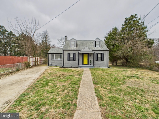 view of front of house featuring a front lawn, fence, concrete driveway, brick siding, and a chimney