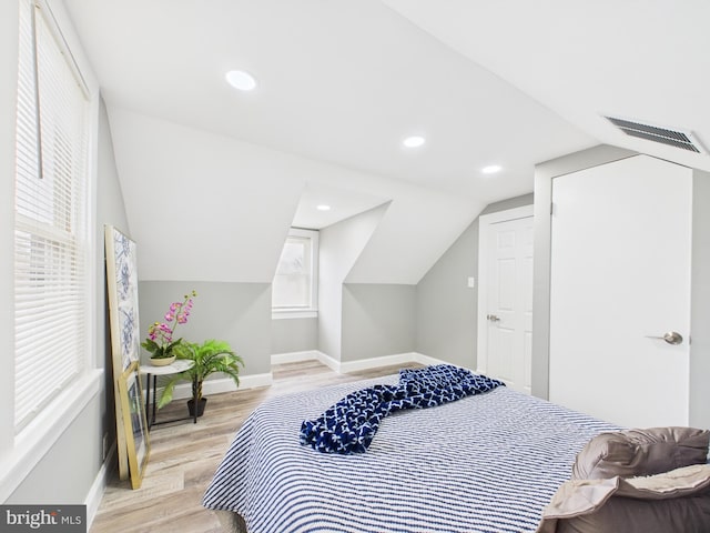 bedroom with visible vents, wood finished floors, recessed lighting, baseboards, and vaulted ceiling