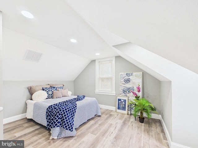 bedroom with wood finished floors, visible vents, baseboards, lofted ceiling, and recessed lighting