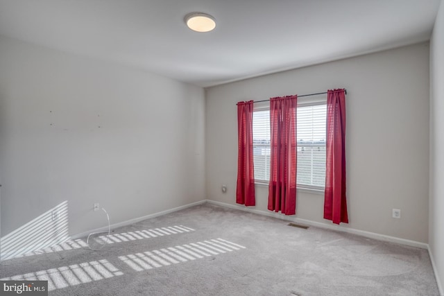 unfurnished room featuring carpet flooring, baseboards, and visible vents