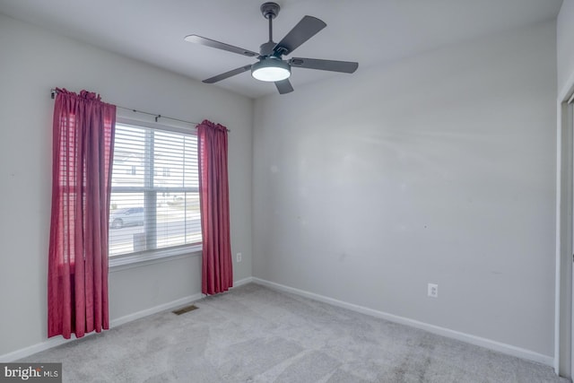 spare room featuring visible vents, baseboards, carpet, and a ceiling fan