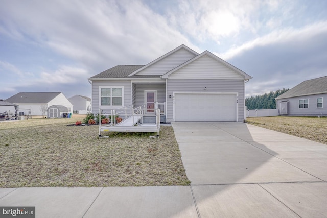 single story home featuring an attached garage, concrete driveway, and a front yard