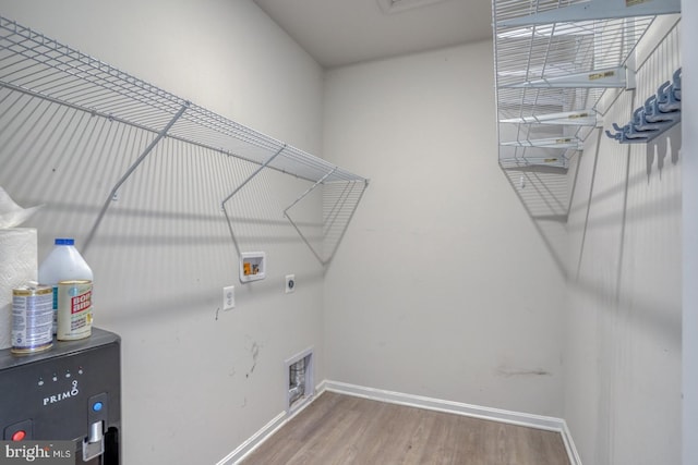 washroom featuring laundry area, hookup for a washing machine, baseboards, and wood finished floors