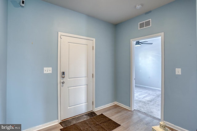 entryway with visible vents, baseboards, and wood finished floors