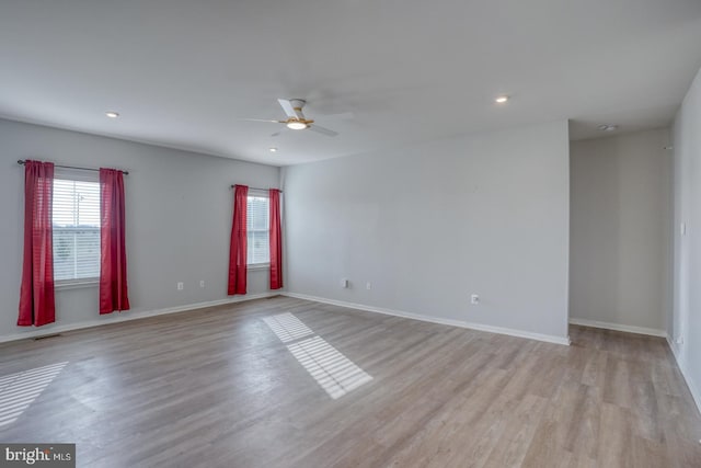 empty room featuring recessed lighting, baseboards, light wood-style flooring, and a ceiling fan