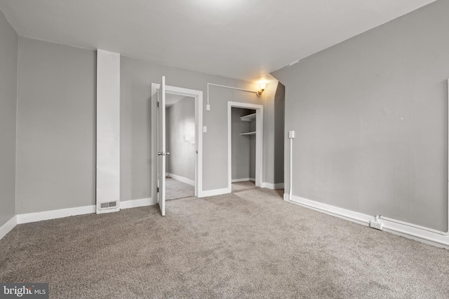 unfurnished bedroom featuring a closet, baseboards, and carpet