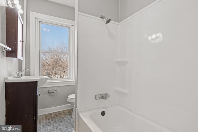 full bathroom featuring vanity, toilet, washtub / shower combination, and baseboards