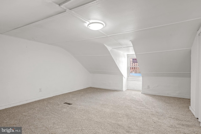 bonus room with carpet flooring and lofted ceiling