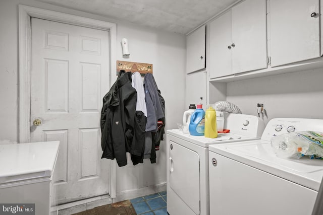 clothes washing area with cabinet space and independent washer and dryer