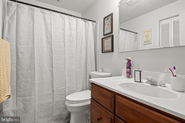 bathroom with visible vents, toilet, and vanity