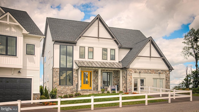 202 Cahill Ln, Severna Park, MD 21146 - view of front of property featuring stone siding, a shingled roof, a fenced front yard, and a standing seam roof