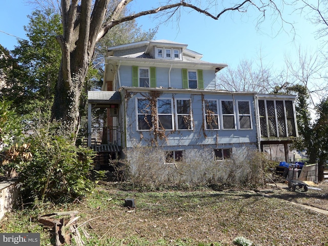 view of property exterior with a sunroom