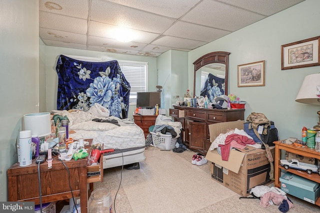 carpeted bedroom with a drop ceiling