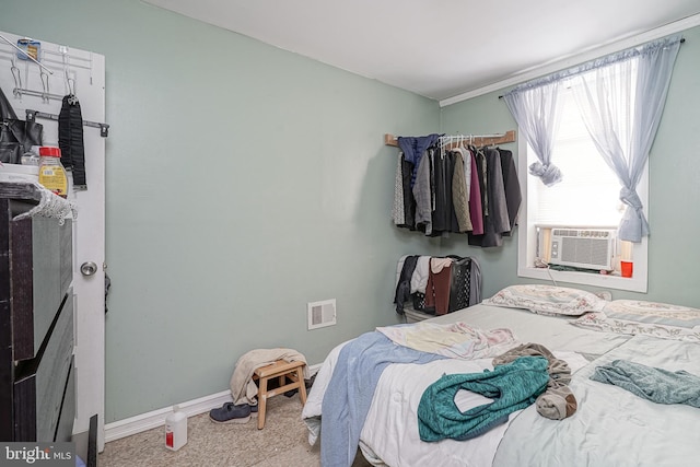 bedroom with visible vents, cooling unit, and baseboards