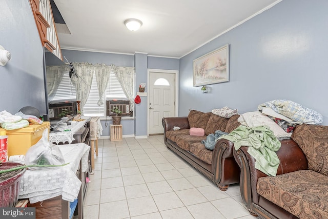 living room with crown molding, light tile patterned floors, and baseboards