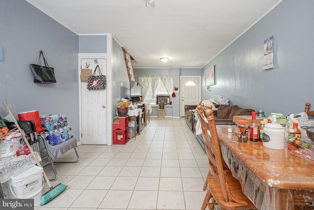 living room featuring light tile patterned floors, baseboards, and ornamental molding