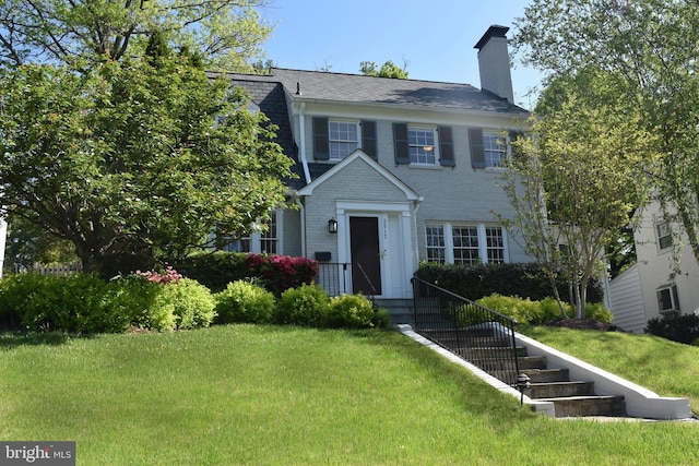 3517 Woodbine St, Chevy Chase, MD 20815 - colonial home featuring a chimney and a front lawn