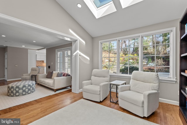 3517 Woodbine St, Chevy Chase, MD 20815 - sitting room featuring a wealth of natural light, vaulted ceiling with skylight, and wood finished floors