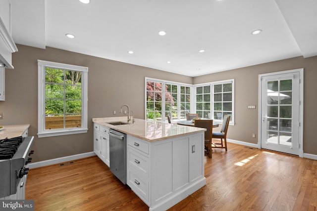 3517 Woodbine St, Chevy Chase, MD 20815 - kitchen featuring a sink, white cabinets, dishwasher, and a healthy amount of sunlight