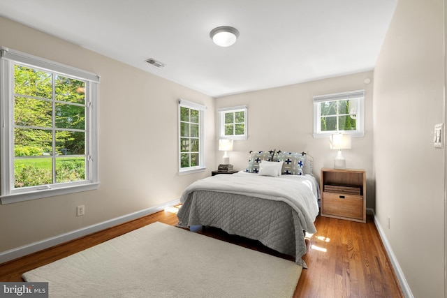 3517 Woodbine St, Chevy Chase, MD 20815 - bedroom featuring baseboards, wood finished floors, and visible vents