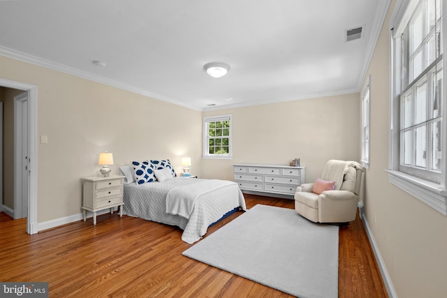 3517 Woodbine St, Chevy Chase, MD 20815 - bedroom with crown molding, wood finished floors, and visible vents