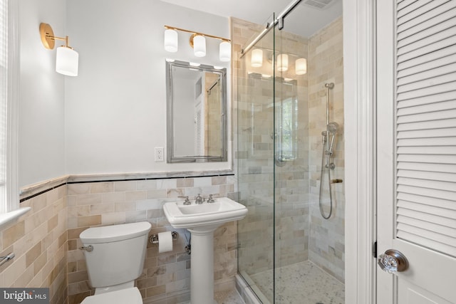 3517 Woodbine St, Chevy Chase, MD 20815 - bathroom with a sink, toilet, a wainscoted wall, tile walls, and a stall shower