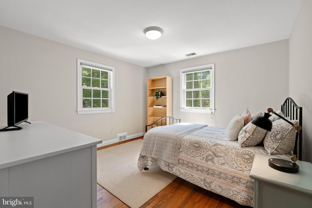 3517 Woodbine St, Chevy Chase, MD 20815 - bedroom with baseboards, visible vents, and wood finished floors