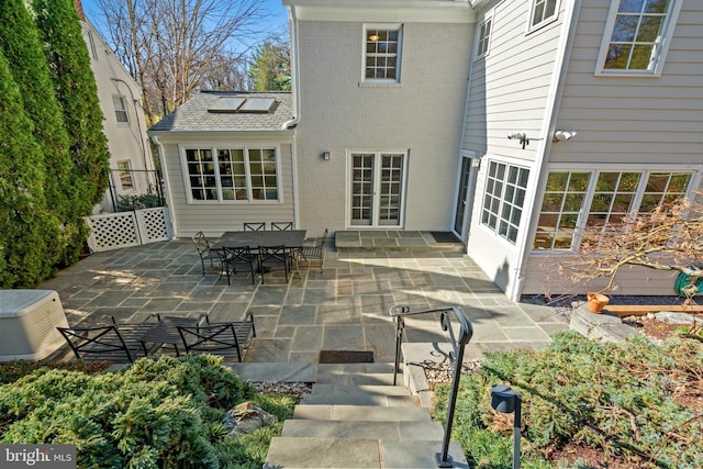 3517 Woodbine St, Chevy Chase, MD 20815 - rear view of property featuring brick siding and a patio area