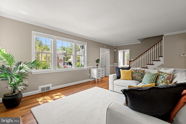 3517 Woodbine St, Chevy Chase, MD 20815 - living area with visible vents, crown molding, wood finished floors, stairway, and baseboards
