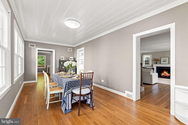 3517 Woodbine St, Chevy Chase, MD 20815 - dining room featuring crown molding, baseboards, wood finished floors, and visible vents
