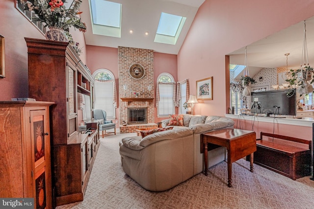 living area featuring a skylight, plenty of natural light, a fireplace, and high vaulted ceiling